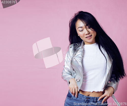 Image of young pretty smiling asian korean girl wearing modern fashion clothers on pink background, lifestyle people concept 