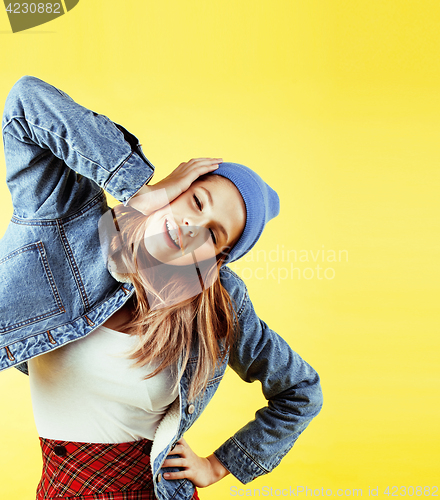 Image of lifestyle people concept: pretty young school teenage girl having fun happy smiling on yellow background 