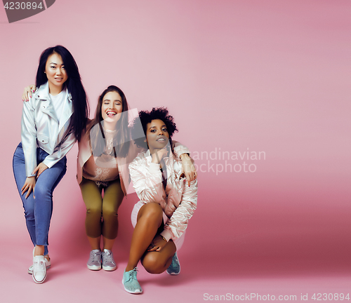 Image of different nation girls with diversuty in skin, hair. Asian, scandinavian, african american cheerful emotional posing on pink background, woman day celebration, lifestyle people concept