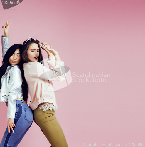 Image of different nation girls with diversuty in skin, hair. Asian, scandinavian, african american cheerful emotional posing on pink background, woman day celebration, lifestyle people concept 