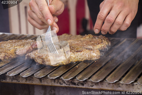 Image of Grilled meat steak on the grill