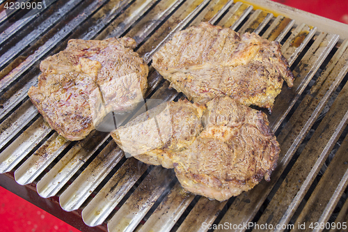 Image of Grilled meat steak on the grill