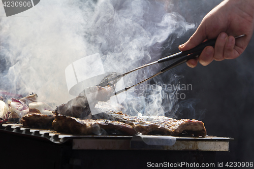 Image of Grilled pork ribs and red chicory on the grill
