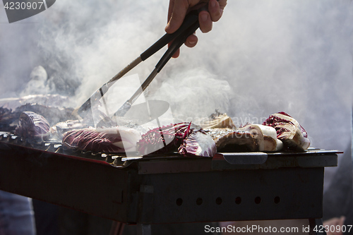 Image of Grilled pork ribs and red chicory on the grill