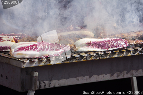 Image of Grilled pork ribs and red chicory on the grill