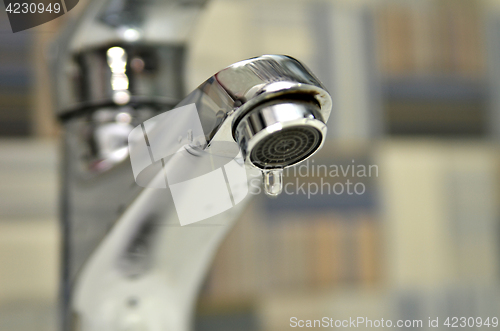 Image of Bathroom tap leaking water drops