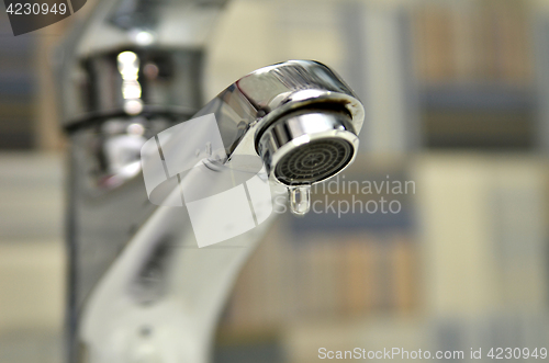 Image of Bathroom tap leaking water drops