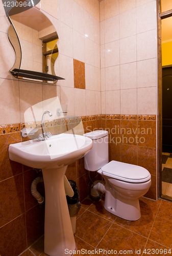 Image of Bathroom in the hotel, washbasin, mirror and toilet