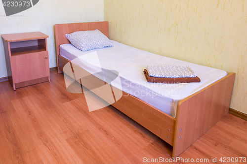 Image of Sleeper - a bed and a bedside table in the interior of the room, close-up