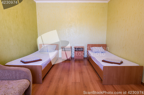 Image of Sleeps - bed and two bedside tables in the interior of the guest room in the house, close-up