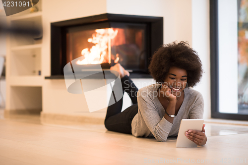 Image of black women using tablet computer on the floor