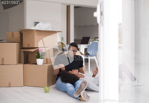 Image of African American couple relaxing in new house