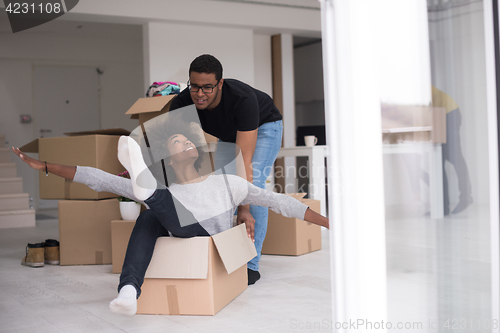 Image of African American couple  playing with packing material