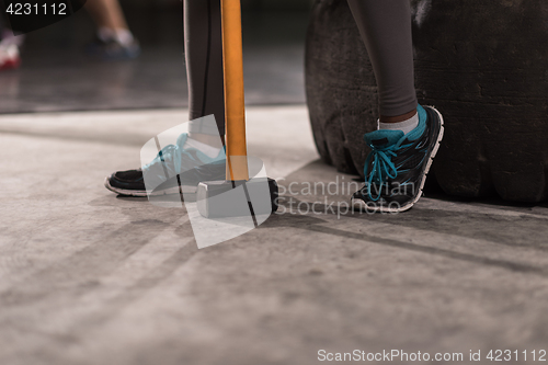 Image of black woman after workout with hammer with focus on legs