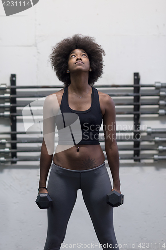 Image of black woman doing bicep curls