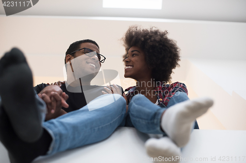 Image of couple having break during moving to new house