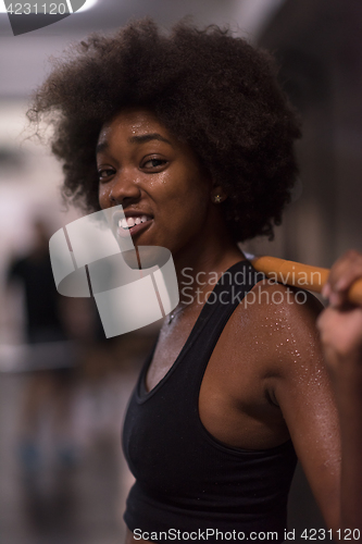 Image of black woman lifting empty bar