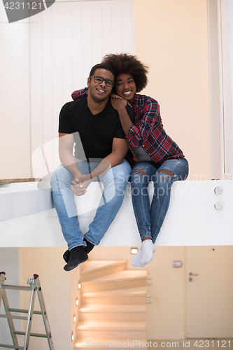 Image of couple having break during moving to new house