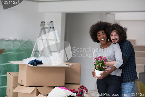 Image of multiethnic couple moving into a new home