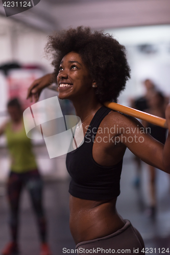 Image of black woman lifting empty bar