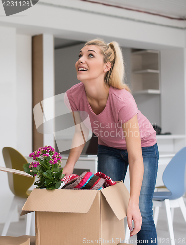 Image of girl moving in the new apartment