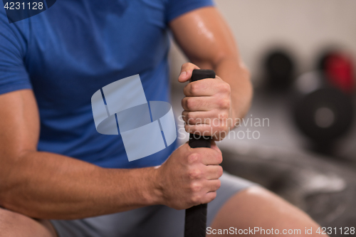 Image of young man after workout with hammer and tractor tire