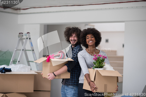 Image of multiethnic couple moving into a new home