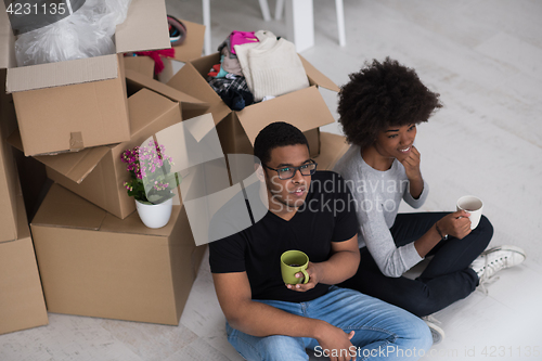 Image of African American couple relaxing in new house