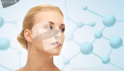 Image of beautiful young woman face with molecules