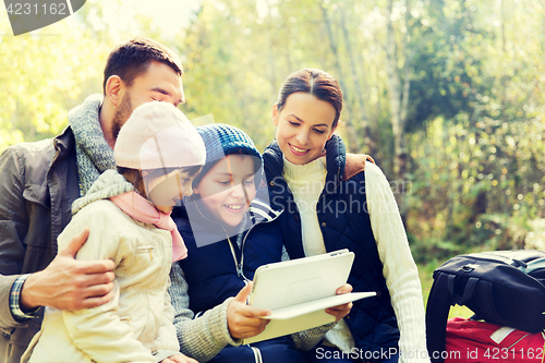 Image of happy family with tablet pc and backpacks at camp