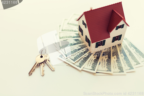 Image of close up of home model, money and house keys