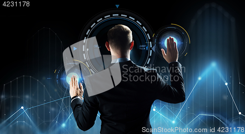 Image of businessman touching virtual screen