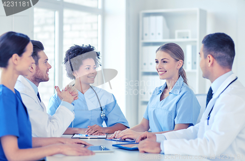 Image of group of happy doctors meeting at hospital office