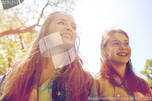 Image of happy teenage student girls or friends outdoors