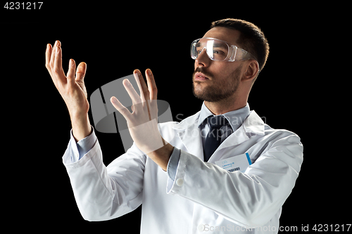 Image of doctor or scientist in lab coat and safety glasses