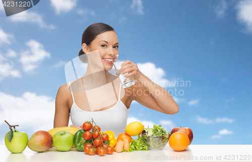 Image of happy woman with glass of water and healthy food