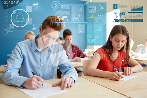 Image of group of students with books writing school test