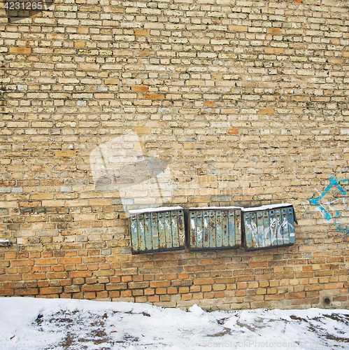 Image of Rusty mailboxes on the wall