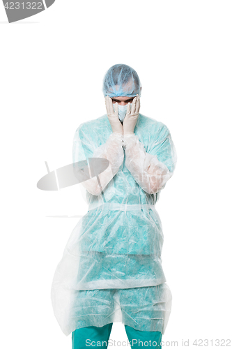 Image of Surgeon portrait. covered face with his hands. sad. isolated on white background