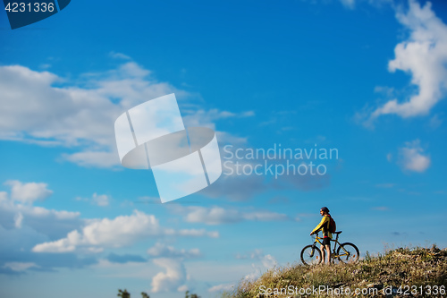 Image of Young man cycling on a rural road