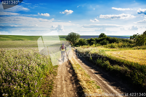 Image of young bright man on mountain bike