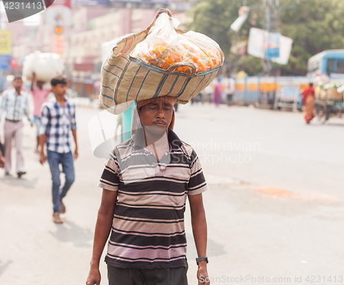 Image of Man carrying flowers