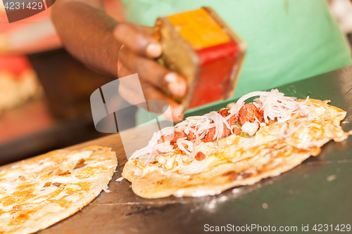 Image of Street vendor preparing egg roll