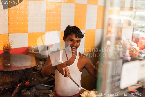 Image of Street vendor preparing egg roll