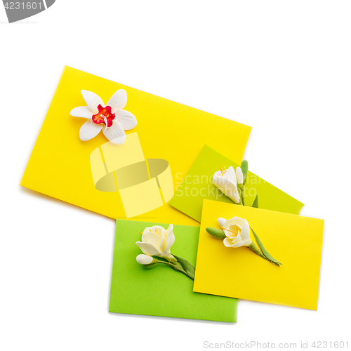 Image of Close up of three yellow envelope with flowers