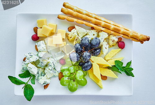 Image of cheese variation on a white table.