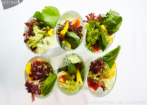 Image of Beetroot salad with avocado and herring in cream sauce in a glass.