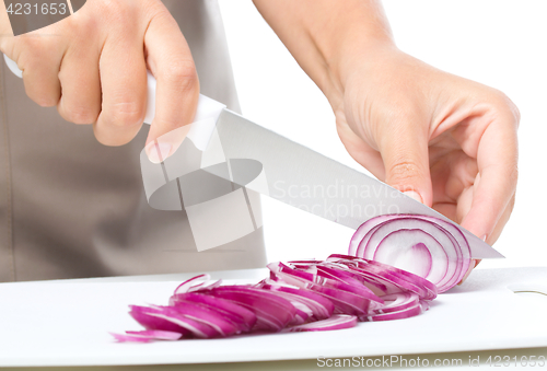 Image of Cook is chopping onion