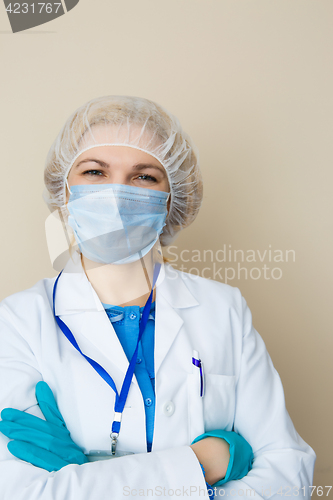 Image of Young woman wearing mask, gloves