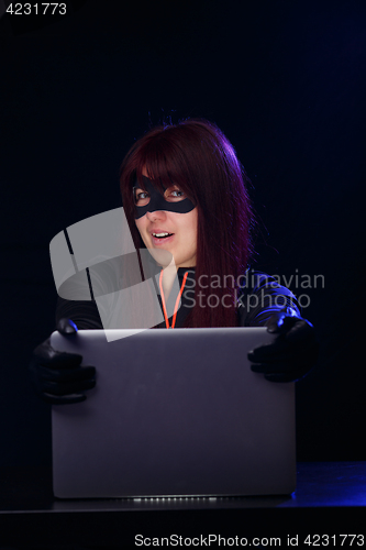 Image of Young brunette hacker at night